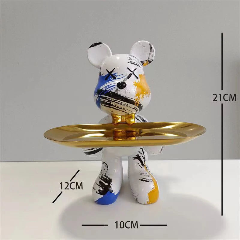 White bear sculpture with rainbow splatter finish on a gold pedestal tray, mirrored backdrop