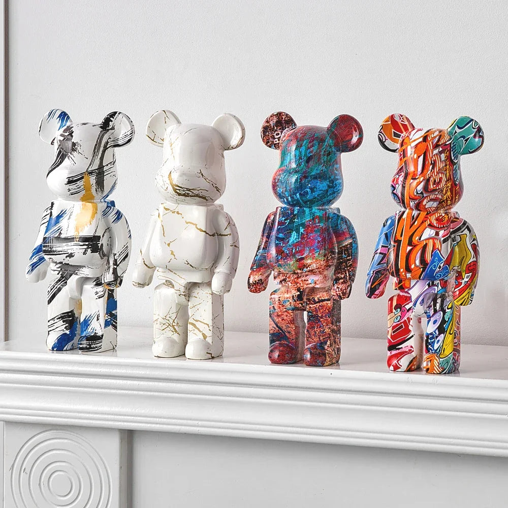 Five blocky bear sculptures in blue, black, silver, and purple finishes