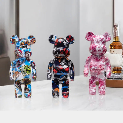 Six blocky bear sculptures in assorted colors arranged on a shelf with warm lighting