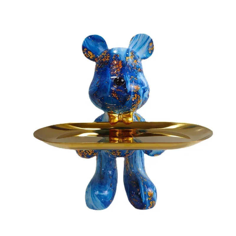 Blue paint-splatter bear sculpture on a gold tray with size reference scale