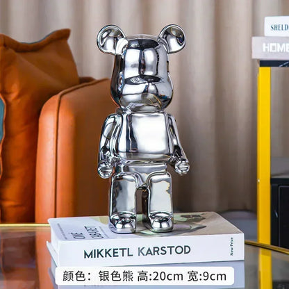 Silver chrome bear sculpture displayed on a side table