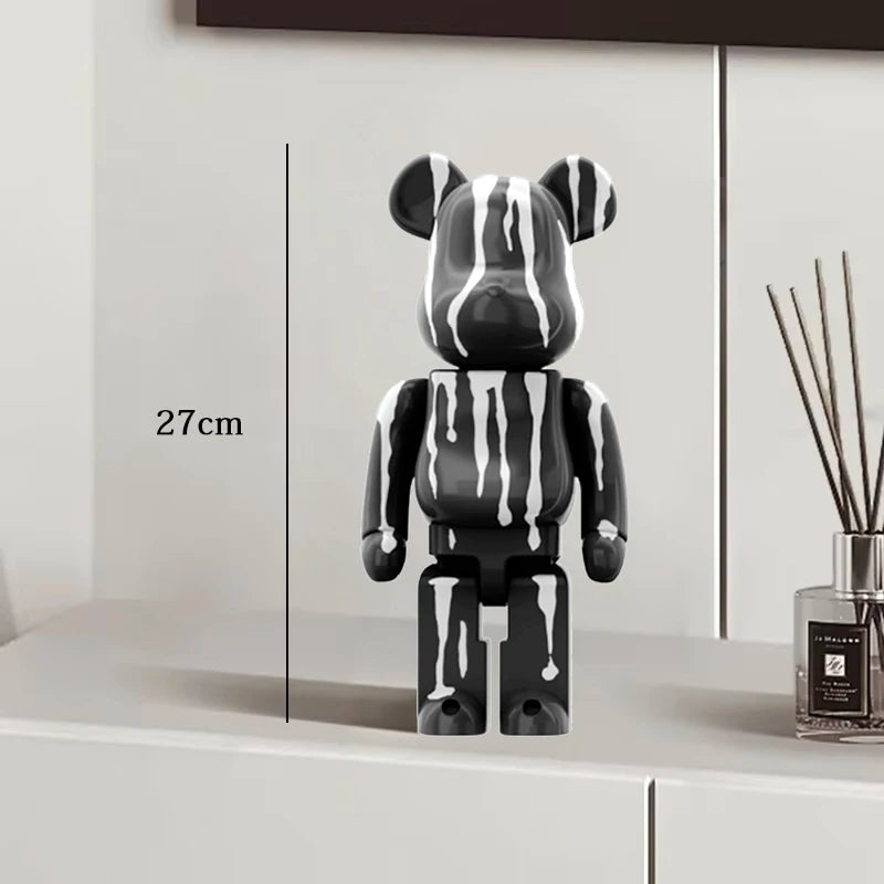 Black blocky bear sculpture standing on a stone ledge