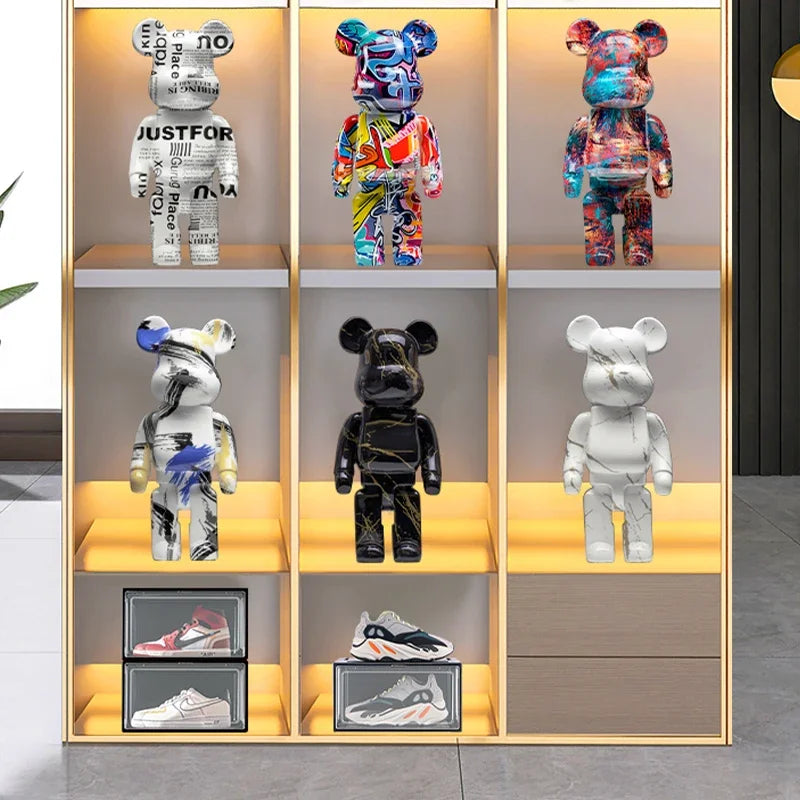 Black blocky bear sculpture displayed on a gray sofa