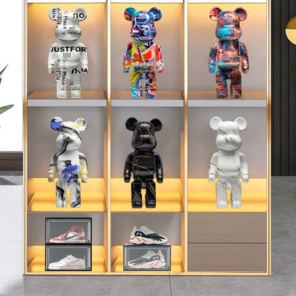 Black blocky bear sculpture displayed on a gray sofa