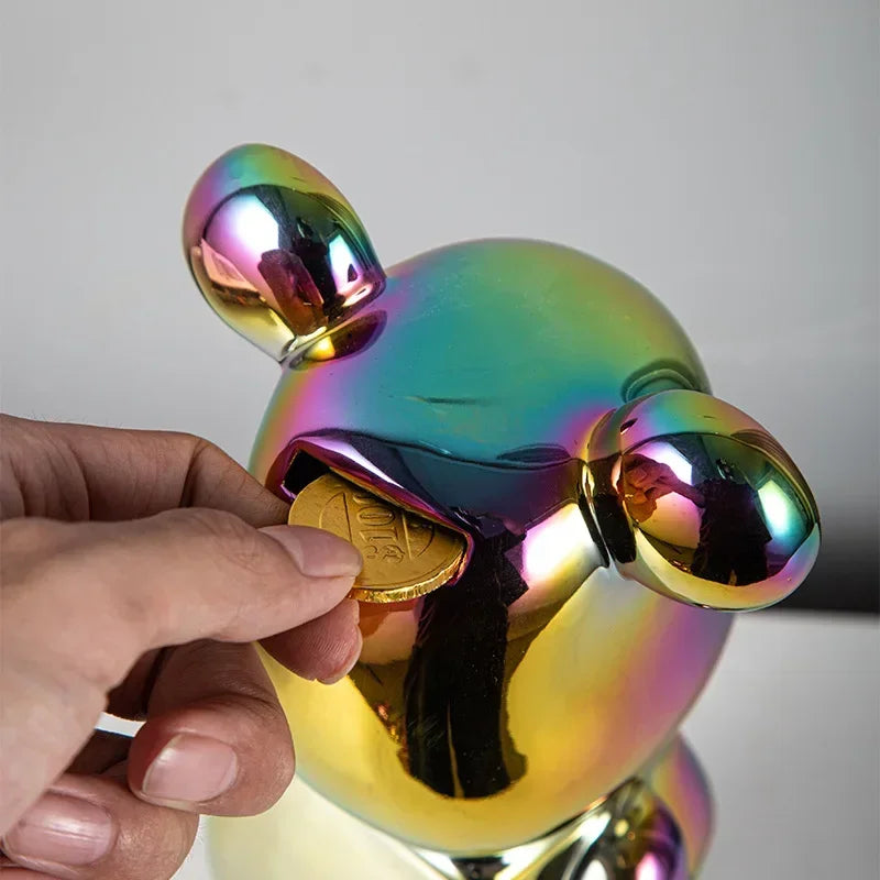 Silver chrome bear sculpture on a couch in a living room setting