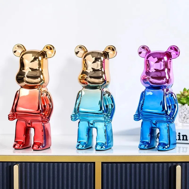 Chrome metallic bear sculptures displayed on a living room console table