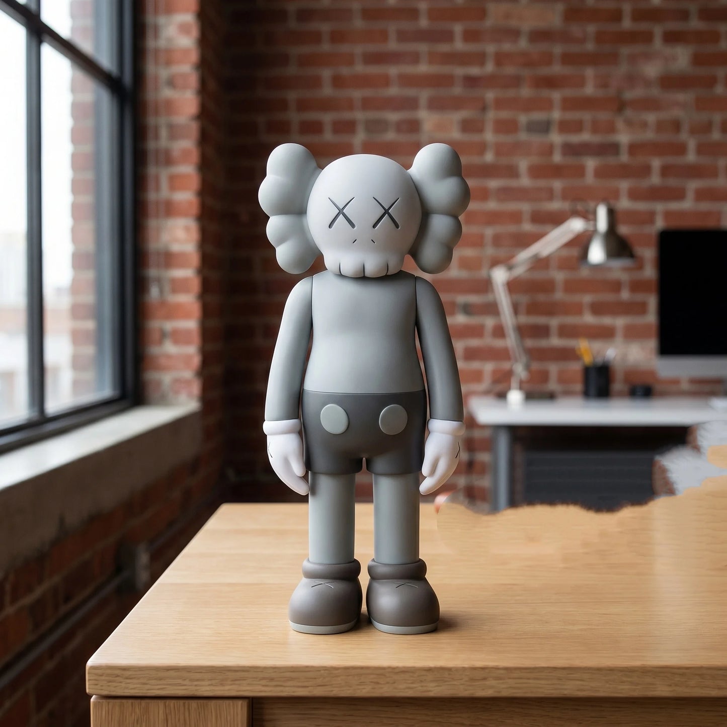 Gray bear figurine displayed on a wood console table near a window
