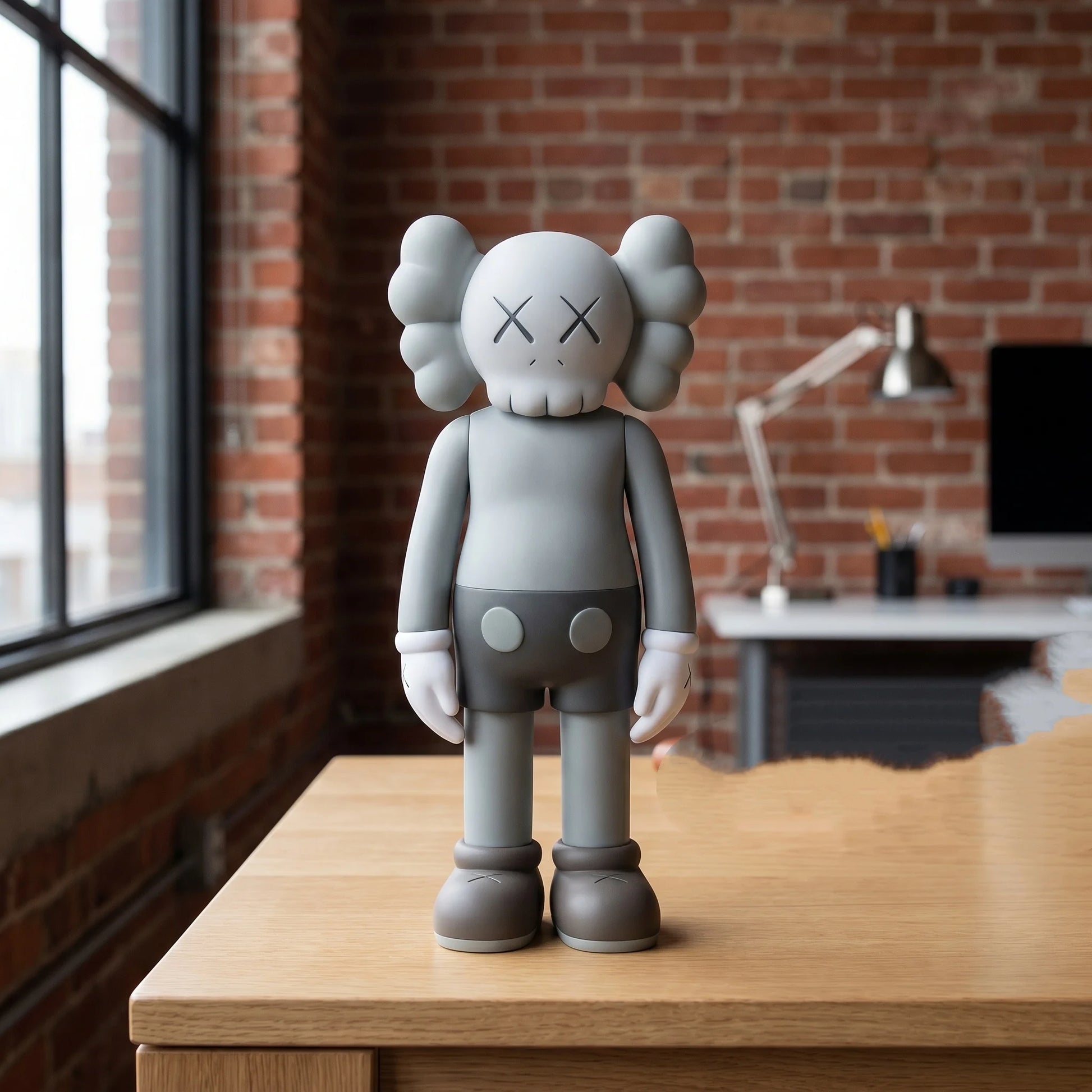Gray bear figurine displayed on a wood console table near a window