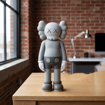 Gray bear figurine displayed on a wood console table near a window