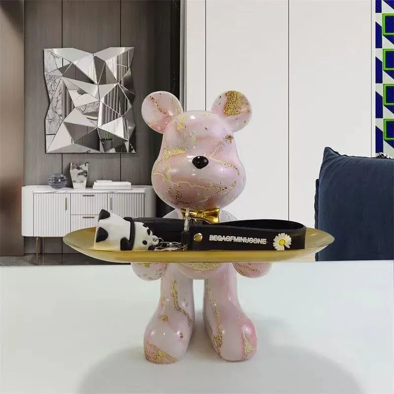 Cream marble-finish bear sculpture on a gold pedestal tray