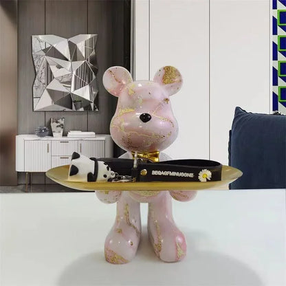 Cream marble-finish bear sculpture on a gold pedestal tray