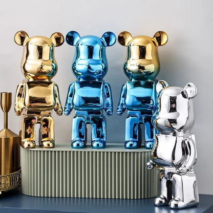 Three metallic-finish blocky bear sculptures displayed on a console table